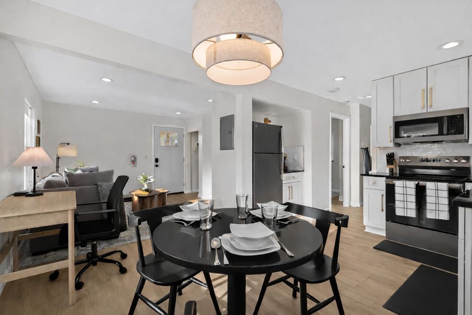Open-concept dining and kitchen area with modern finishes, stylish lighting, and seamless flow into the living space—perfect for dining, working, and relaxing.
