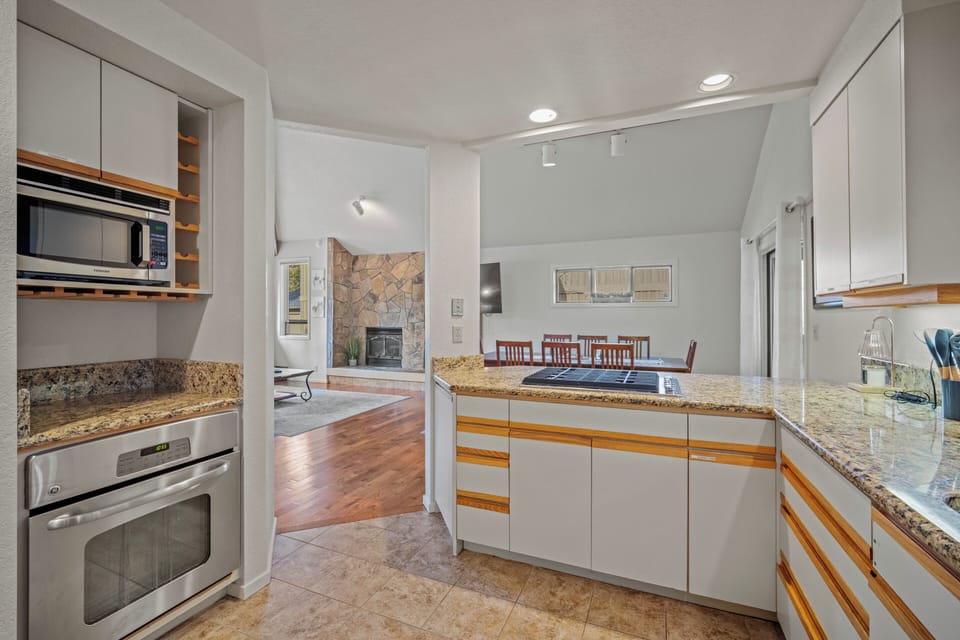 Your fully equipped kitchen features granite countertops, stainless steel appliances, and ample space for preparing memorable meals during your stay.