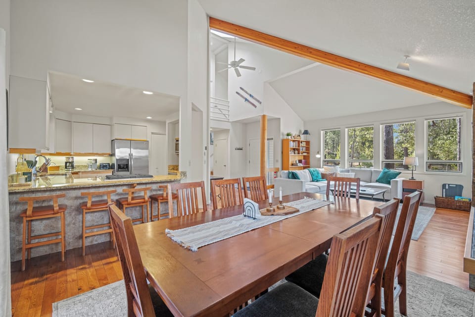 Your open-concept living space flows seamlessly from kitchen to dining to living areas, perfect for gathering with loved ones while natural light pours through expansive windows.