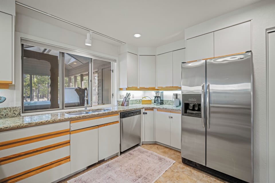 Your modern kitchen features granite countertops, stainless steel appliances, and bright natural light streaming through large windows.