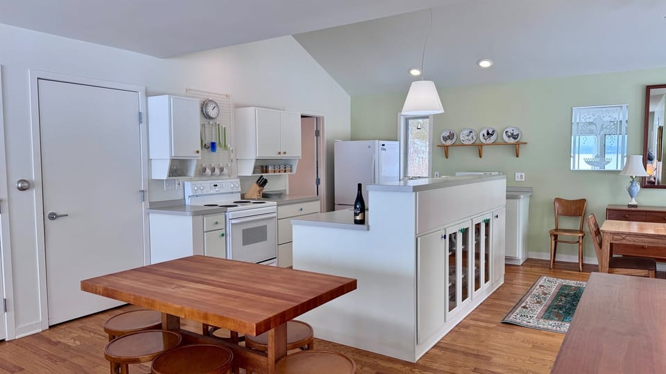 Spacious kitchen with island seating and dining area.