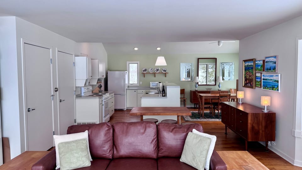 Open-concept living space connecting kitchen, dining, and lounge areas.