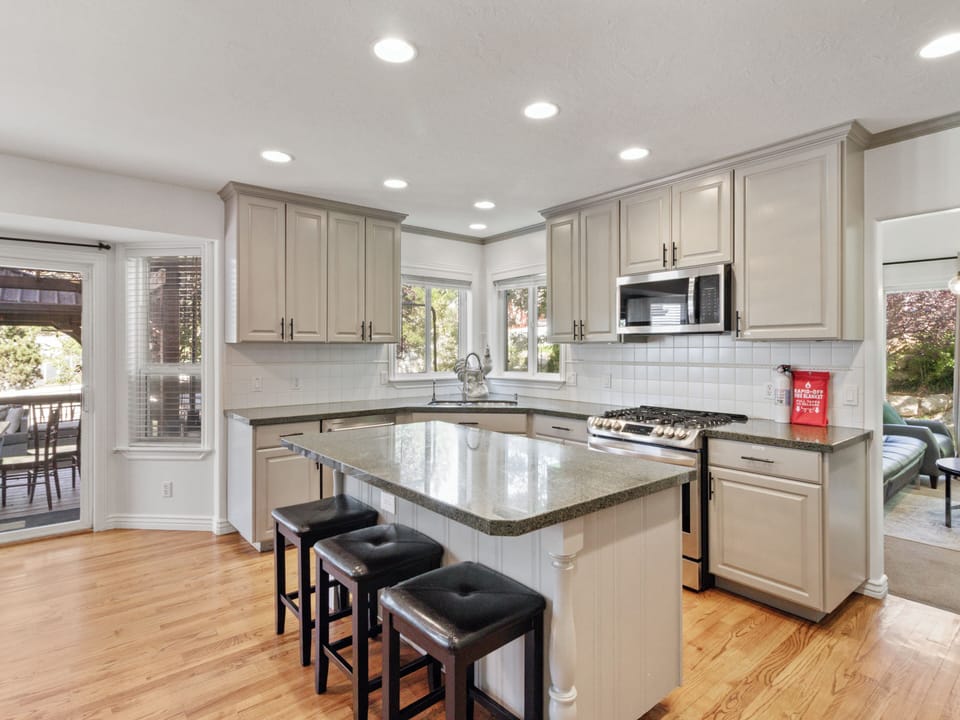 Main floor kitchen with gas range, refrigerator, dinner plates, bowls, glasses, utensils, pots, pans, serving dishes, blender, mixer, emersion mixer, large crock pot, aluminum foil, parchment paper, dish soap, dishwasher soap, hand soap, sponge. 