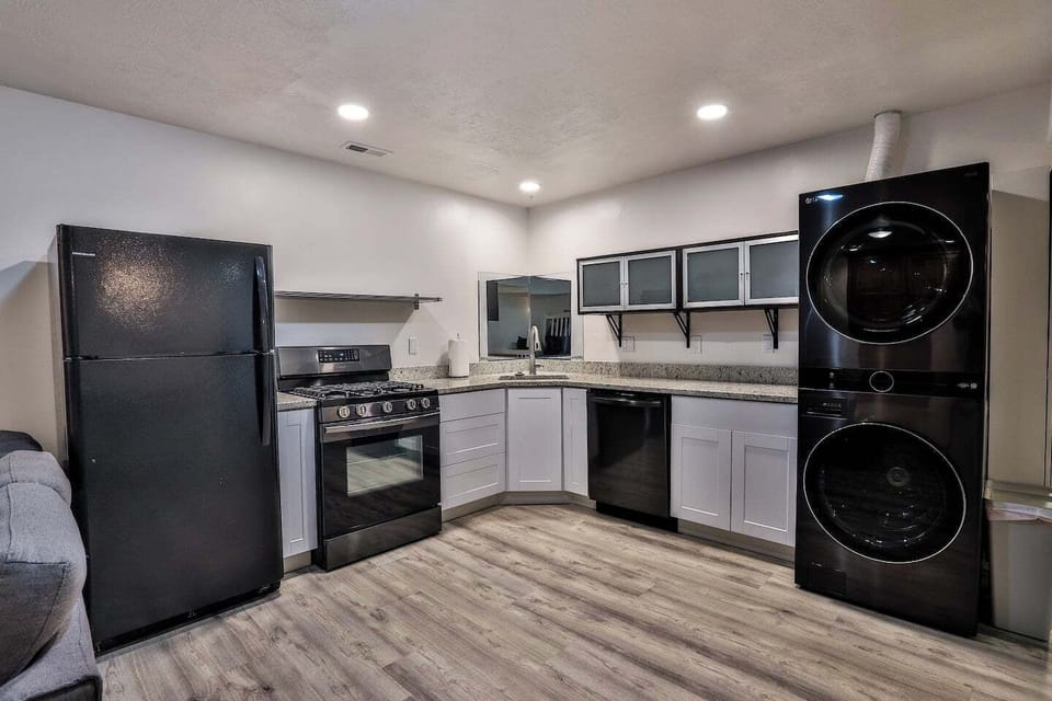 Basement kitchen #2 next to 2 queen bed and bunk bed. Includes W/D, laundry detergent, dryer sheets, dishwasher, range, sink, and refrigerator.