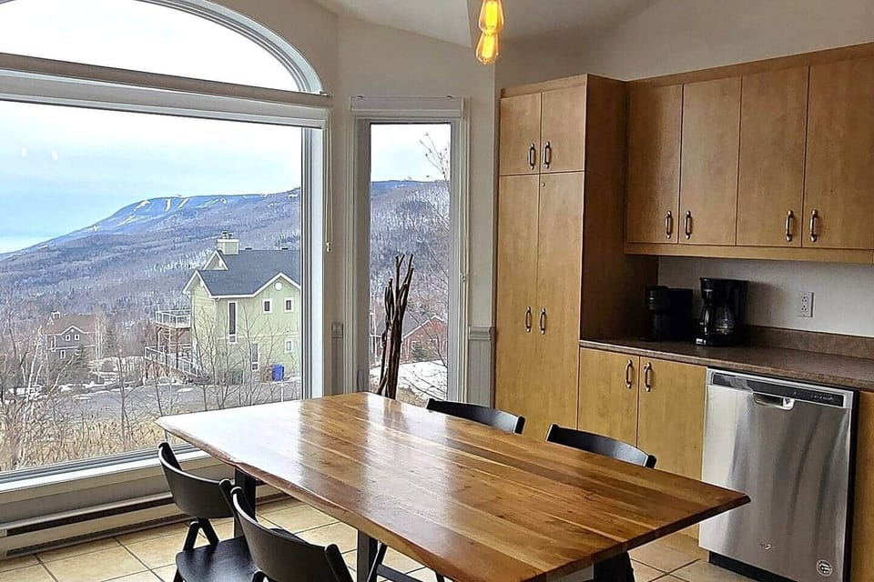 Kitchen and dining room view to river and Massif