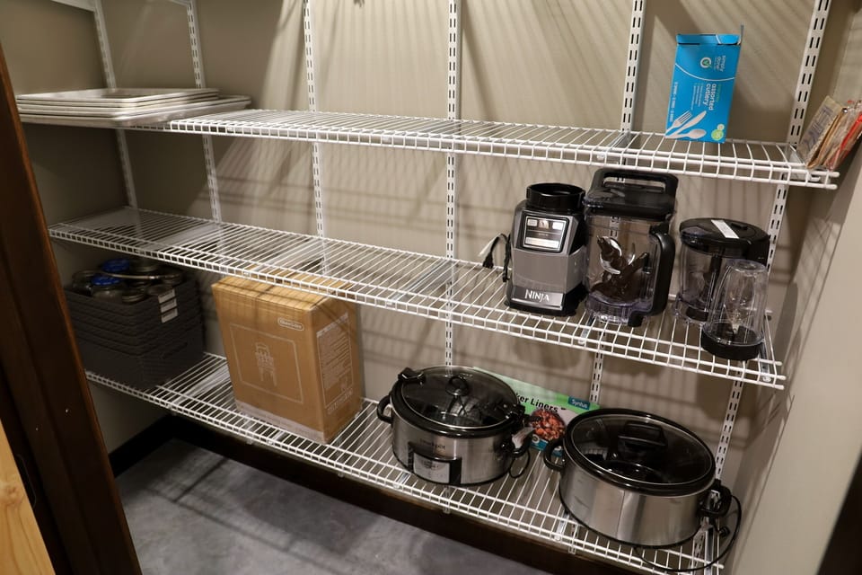 Large pantry with 2 crockpots and blender. Highchair included
