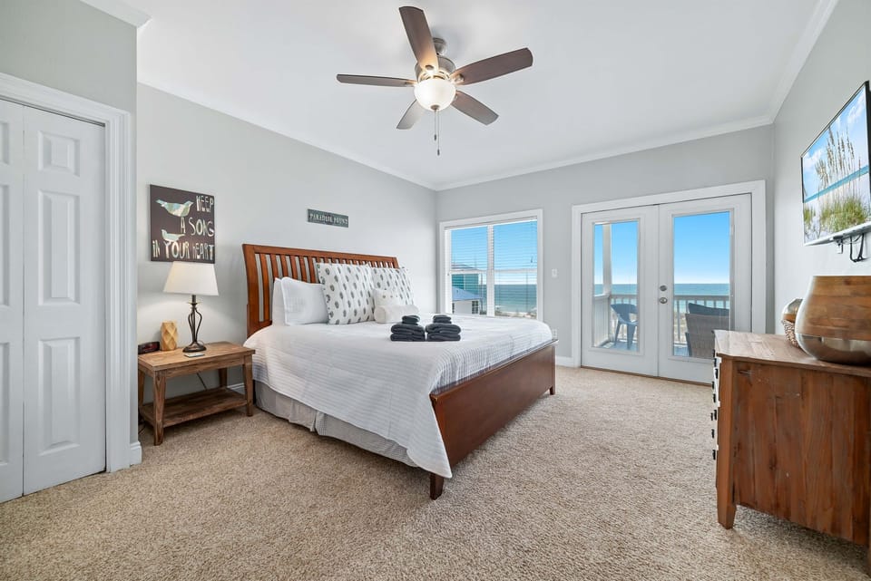 Relaxing bedroom retreat with Gulf views and direct balcony access.