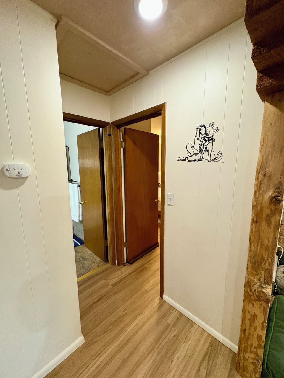 Doorway to bathroom on left and primary bedroom on right