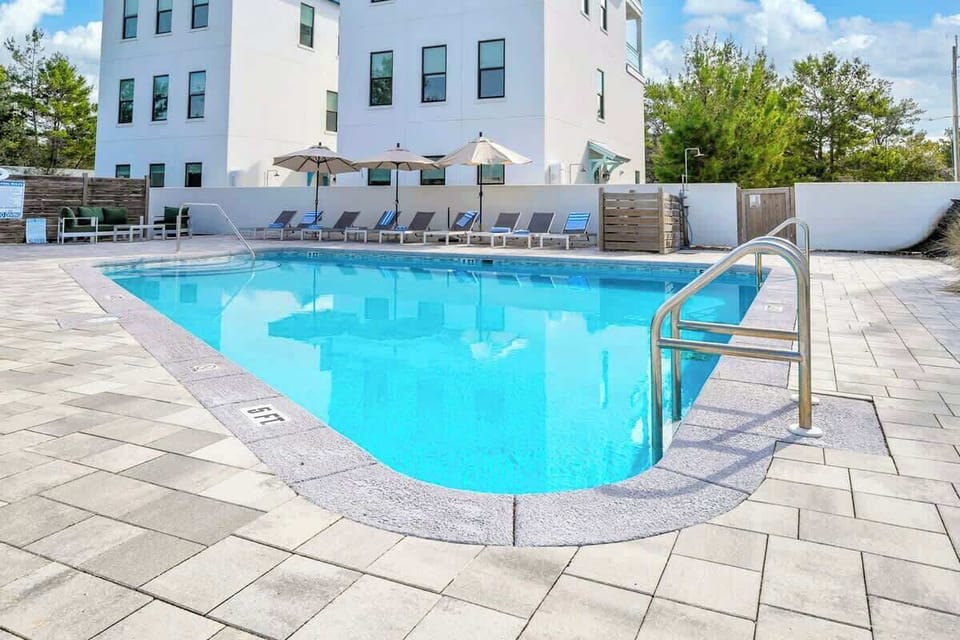Unwind at the large heated communal pool, offering abundant lounge chairs for your comfort.