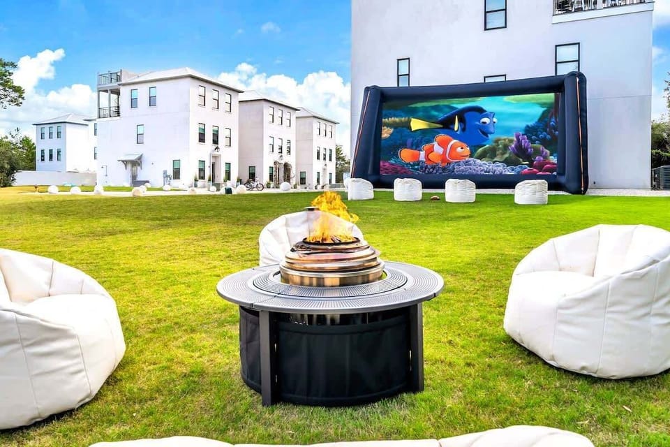 Spacious green space ideal for outdoor movie nights and cozy bonfire gatherings. **Movie projector available for an additional fee.