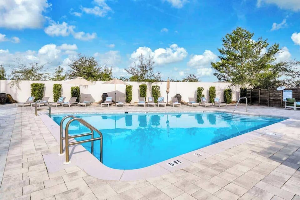 Unwind at the large heated communal pool, offering abundant lounge chairs for your comfort.