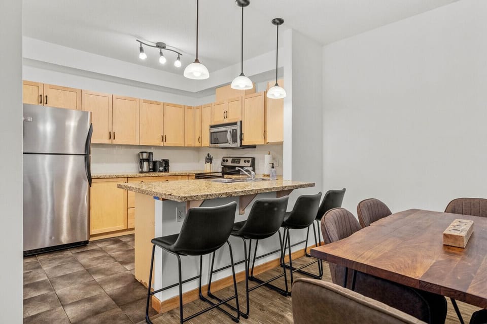 Dining area with seating for 6 and kitchen island with 3 stools for casual meals or snacks.