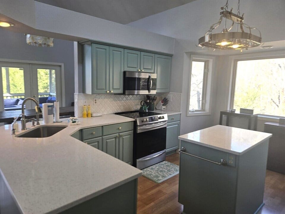 Beautifully updated kitchen with plenty of counterspace to prepare and serve a family meal.