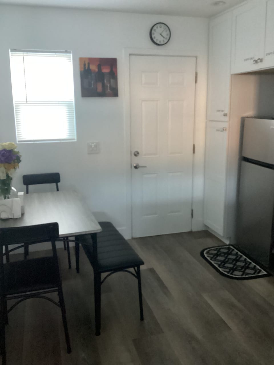 Kitchen area with dining table and refrigerator