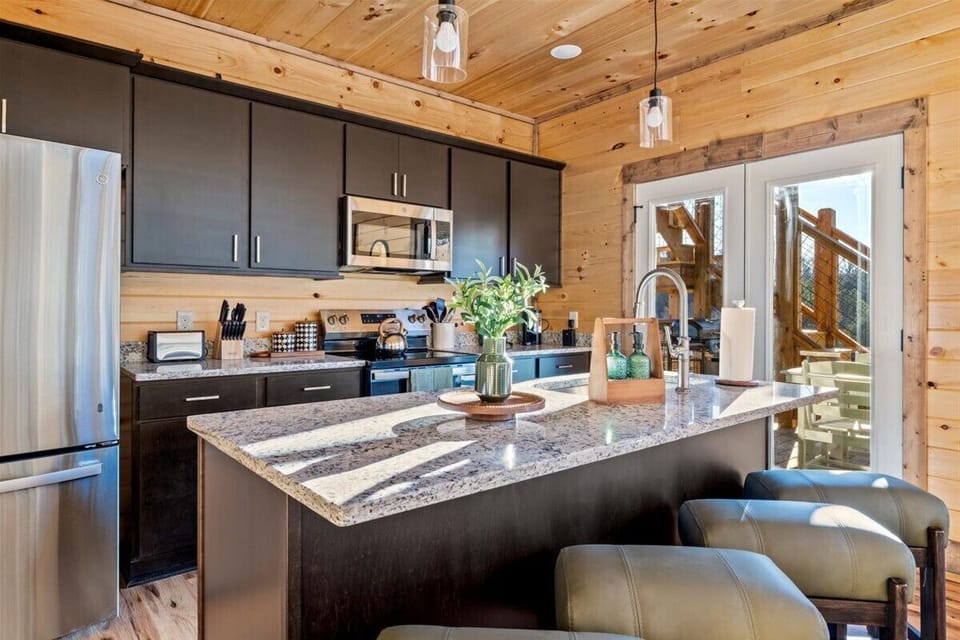 Your fully-equipped kitchen features granite counters, modern appliances, and rustic pine charm—perfect for preparing home-cooked meals in mountain comfort.