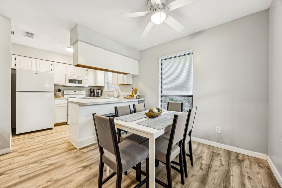 Your bright dining space flows seamlessly into a fully-equipped kitchen, perfect for sharing meals with loved ones.