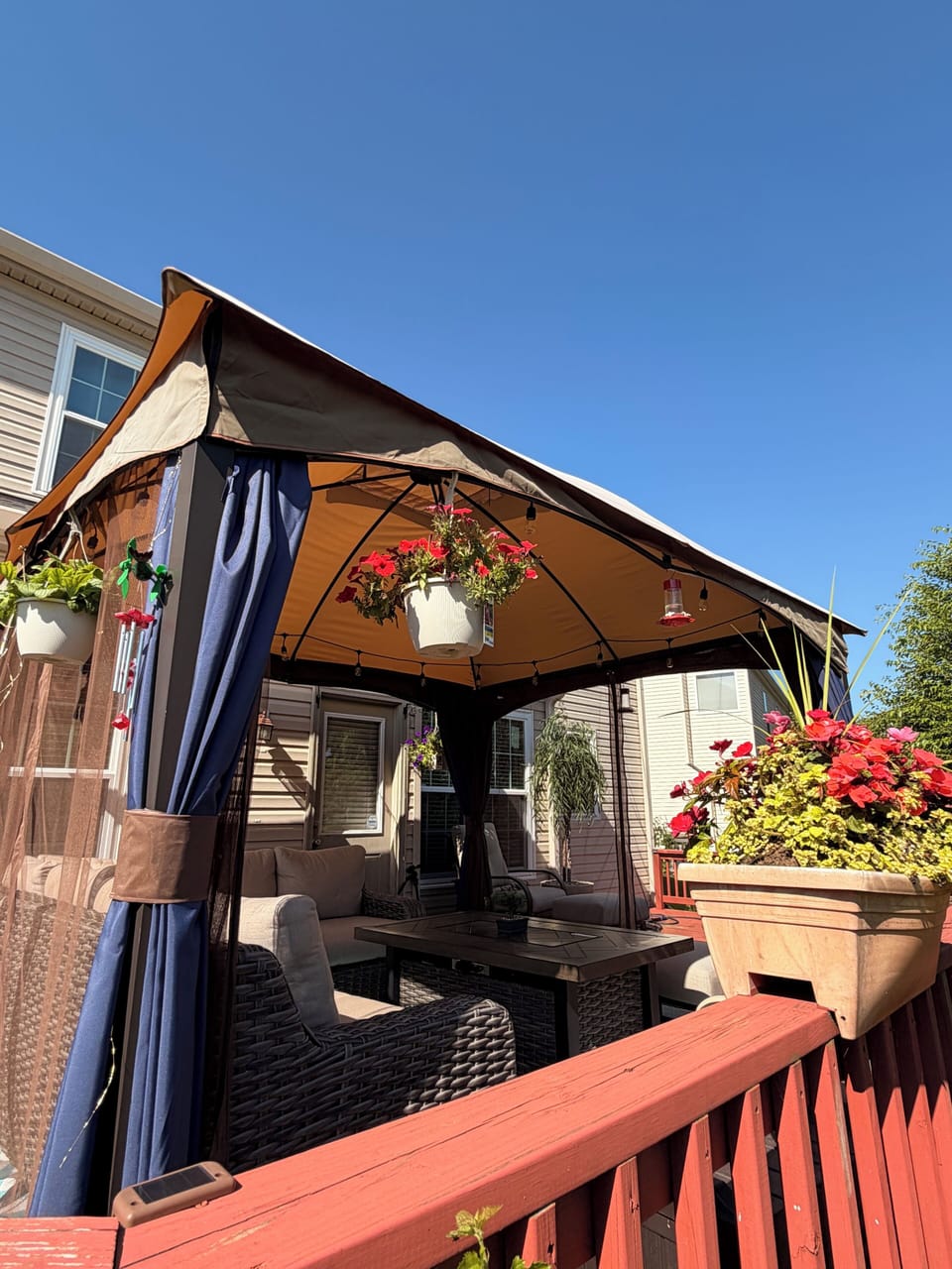 Unwind in the dreamy gazebo with curtains, string lights, and a glowing fire pit