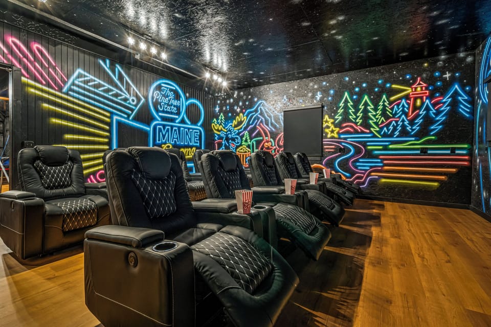 Theater room, artist painted mural, 10 reclining seats, 85” Roku Tv, &candy bar