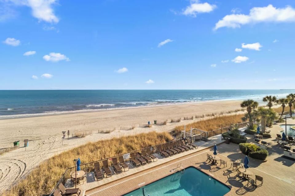 Dive into beachfront bliss with sparkling pool and endless views.