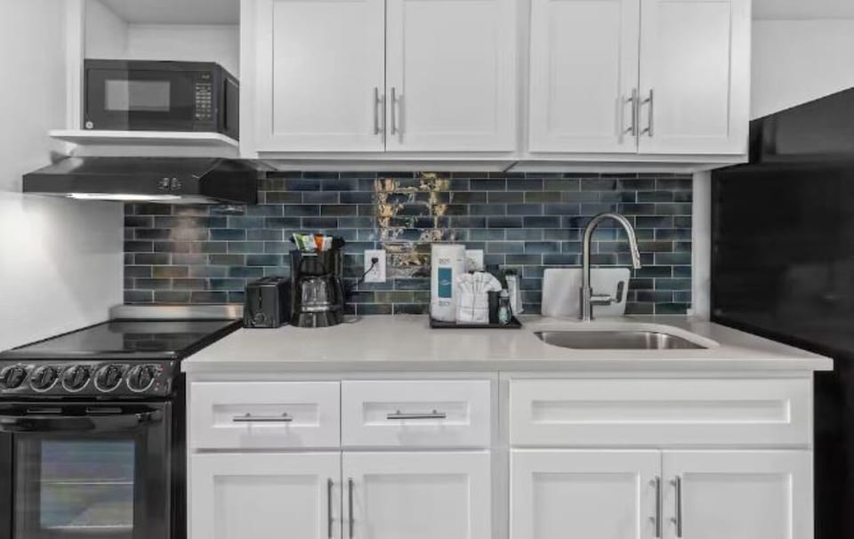 Cook seaside meals with a full kitchen and coffee setup.