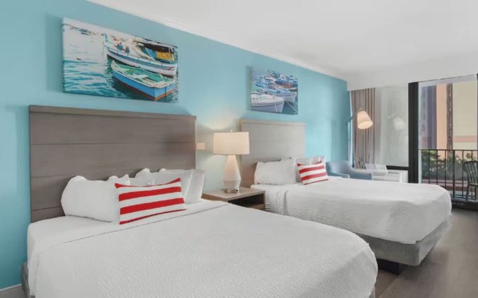 Relax in coastal comfort with soft lighting and roomy beds.