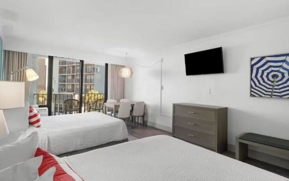 Wake up to balcony breezes from these inviting queen beds.