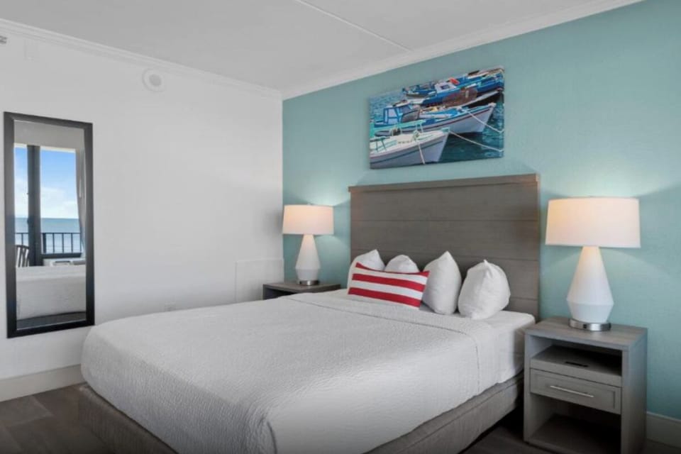 Unwind in crisp linens with a hint of ocean beyond.
