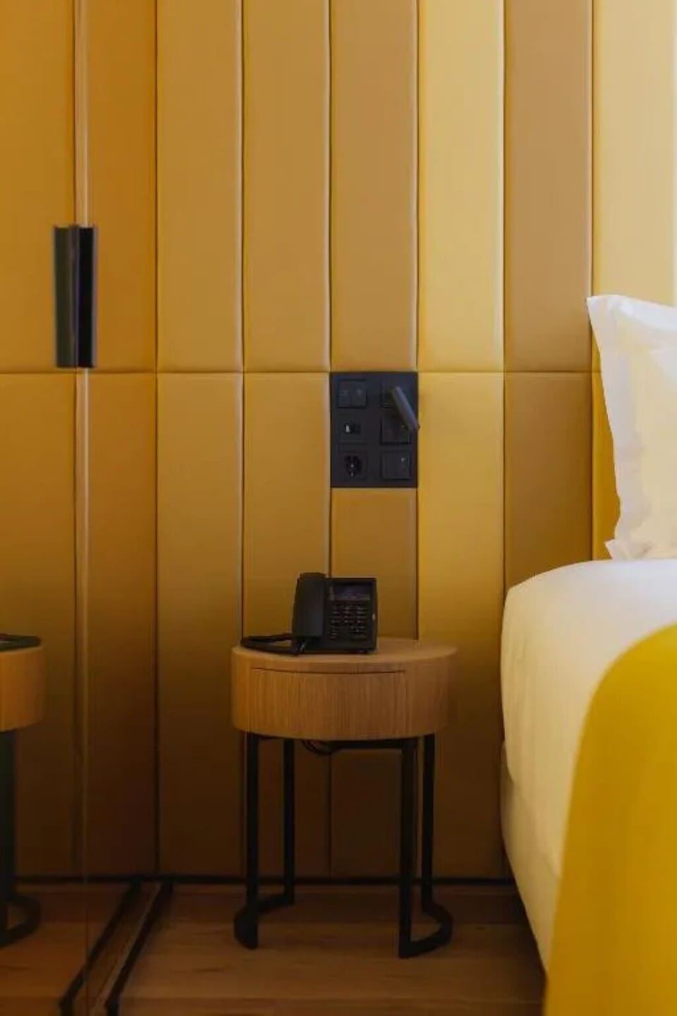 Drift off beside warm ambient lighting and plush bedside touches.