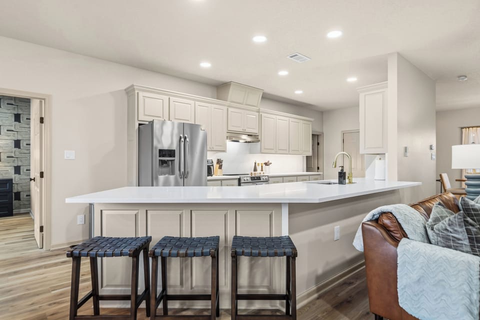 Bright, fully equipped kitchen with expansive counters and modern finishes.