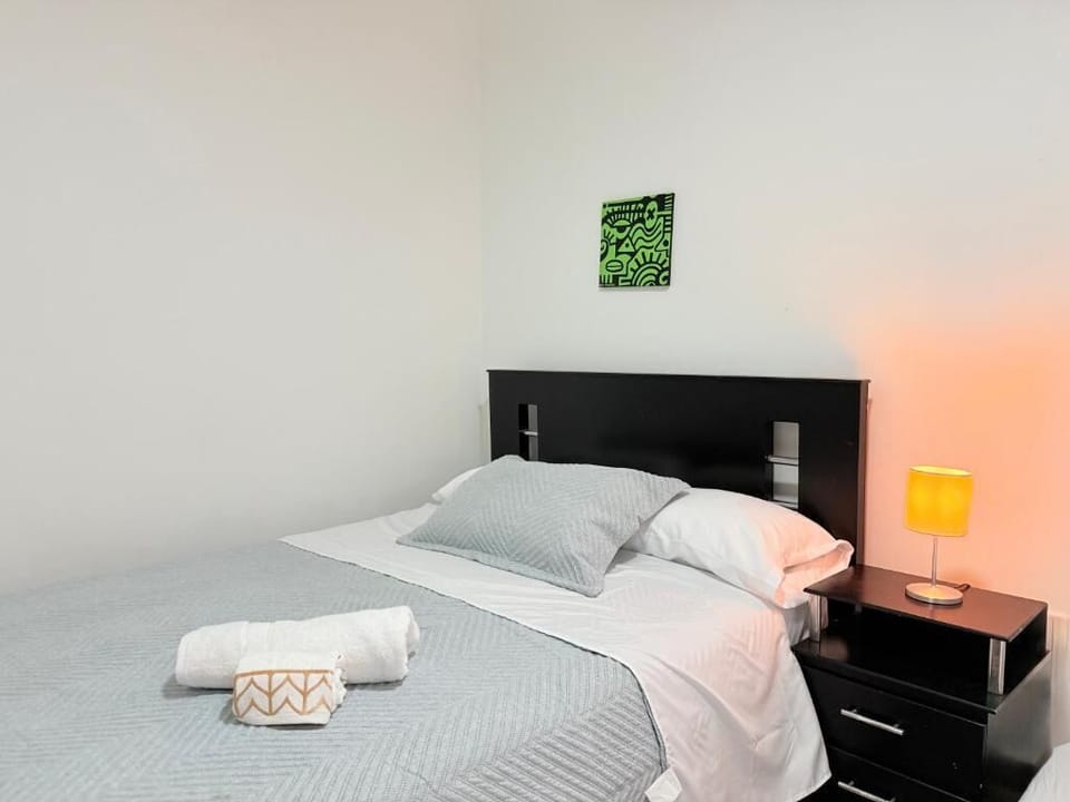 Desk, laptop workspace, blackout drapes, iron/ironing board