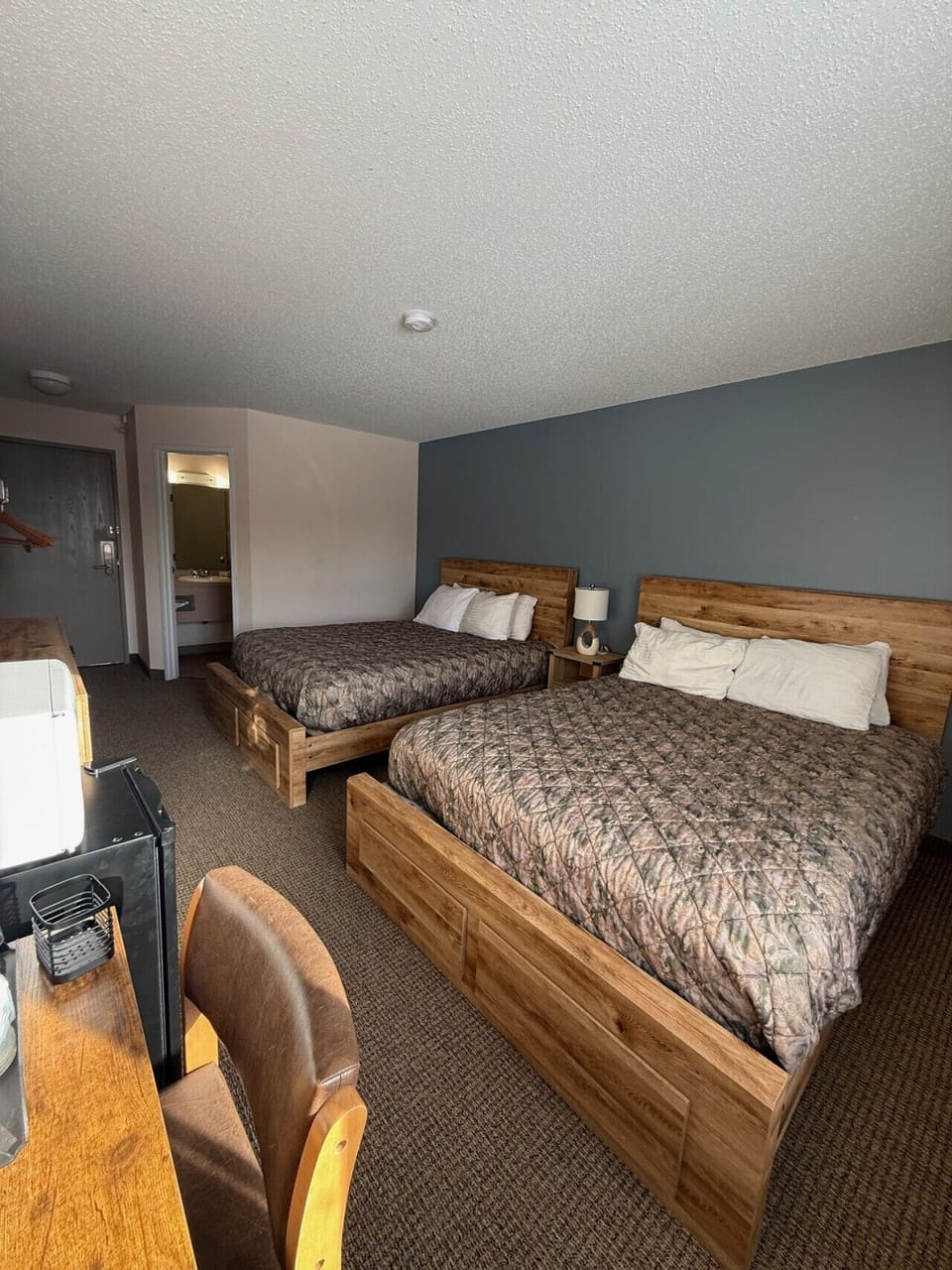 Lodge-style guest room offering two queen beds and rustic accents.