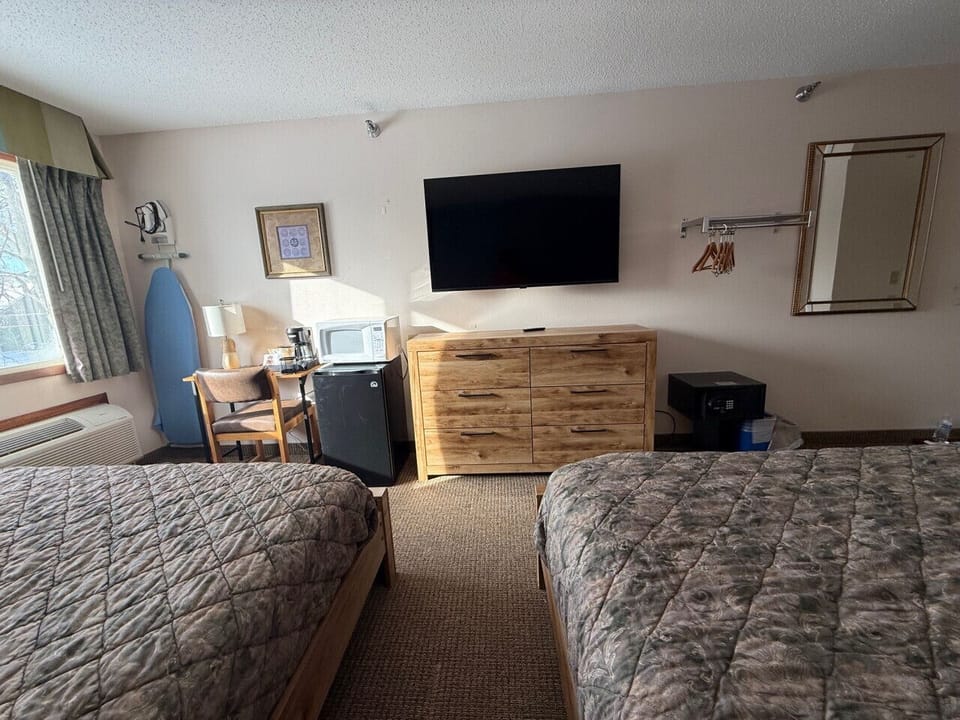 In-room media area offering a mini-fridge and convenient storage solutions.