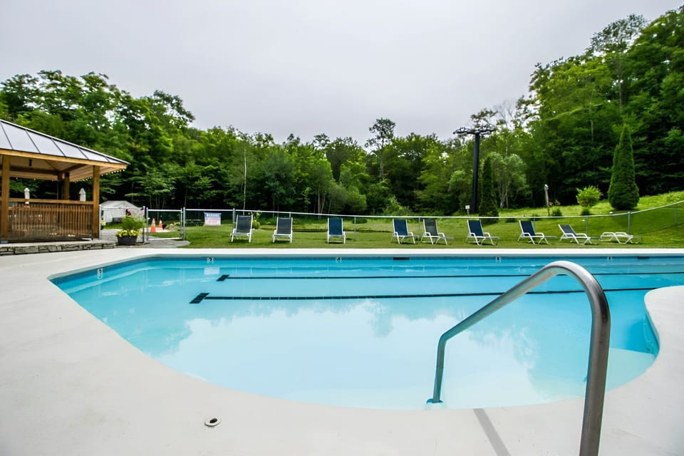 Spend a sunny afternoon by the outdoor pool, with lounge seating spread across the deck.