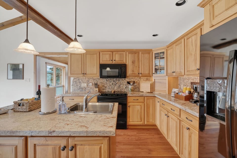 Enjoy a fully equipped kitchen with complete cookware and dining essentials, including wine glasses—plus dishwasher, microwave, stove/oven, refrigerator/freezer, toaster, and a fully stocked coffee bar & tea station.
