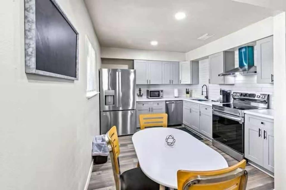Fully equipped kitchen with stainless steel appliances, sleek quartz counters, and everything you need to cook and dine in comfort.