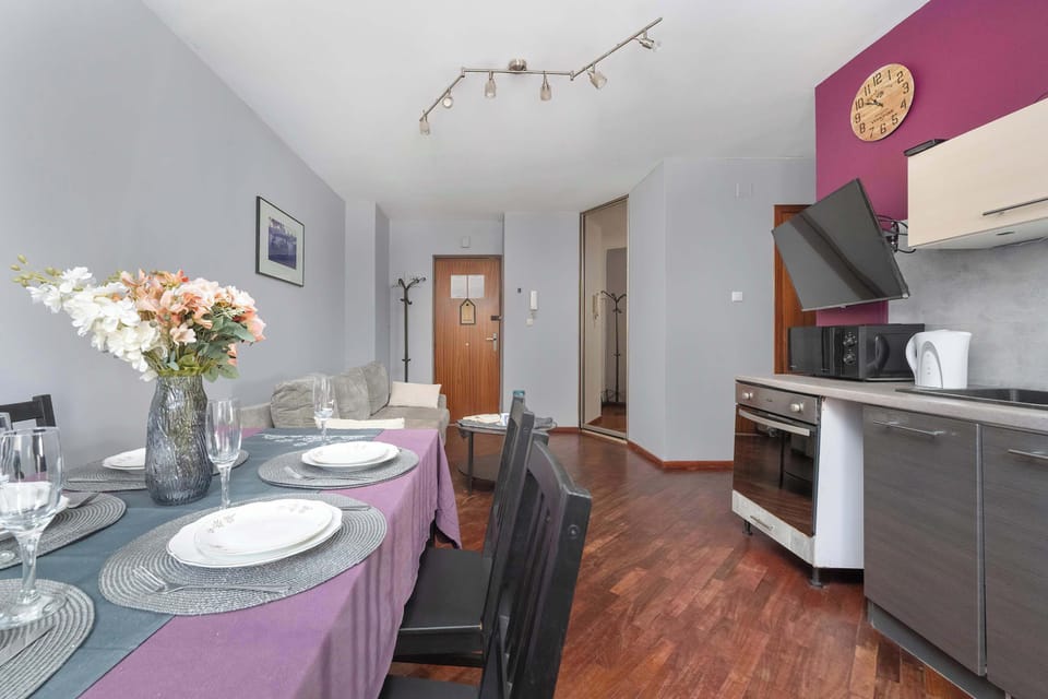 Dining area with table set and kitchen view.