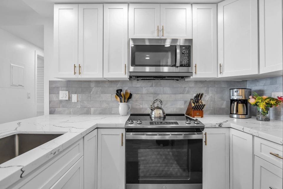 Bright open layout kitchen with stainless steel range, microwave, and dishwasher for easy meal prep and clean-up. Lots of trash bags, dish soap, dishwasher soap and a Brita Filtered water pitcher provided. Your island home away from home! 