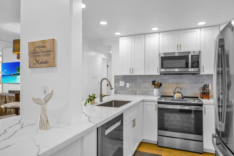 Bright open layout kitchen with stainless steel range, microwave, and dishwasher for easy meal prep and clean-up. Lots of trash bags, dish soap, dishwasher soap and a Brita Filtered water pitcher provided. Your island home away from home! 