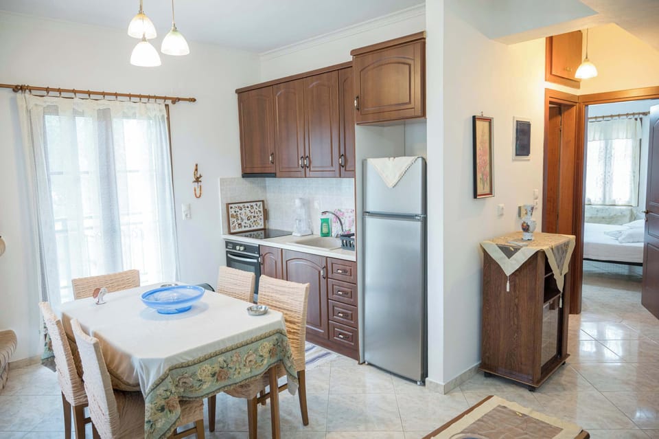 Dining area with natural light and kitchen access.