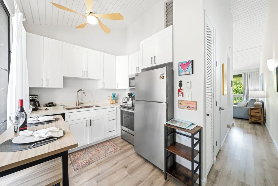 White cabinets and full-size appliances make simple meals easy between beach days.