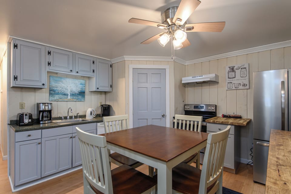 Your cozy kitchen invites memorable meals with warm wood accents, modern appliances, and plenty of space to cook and dine together.