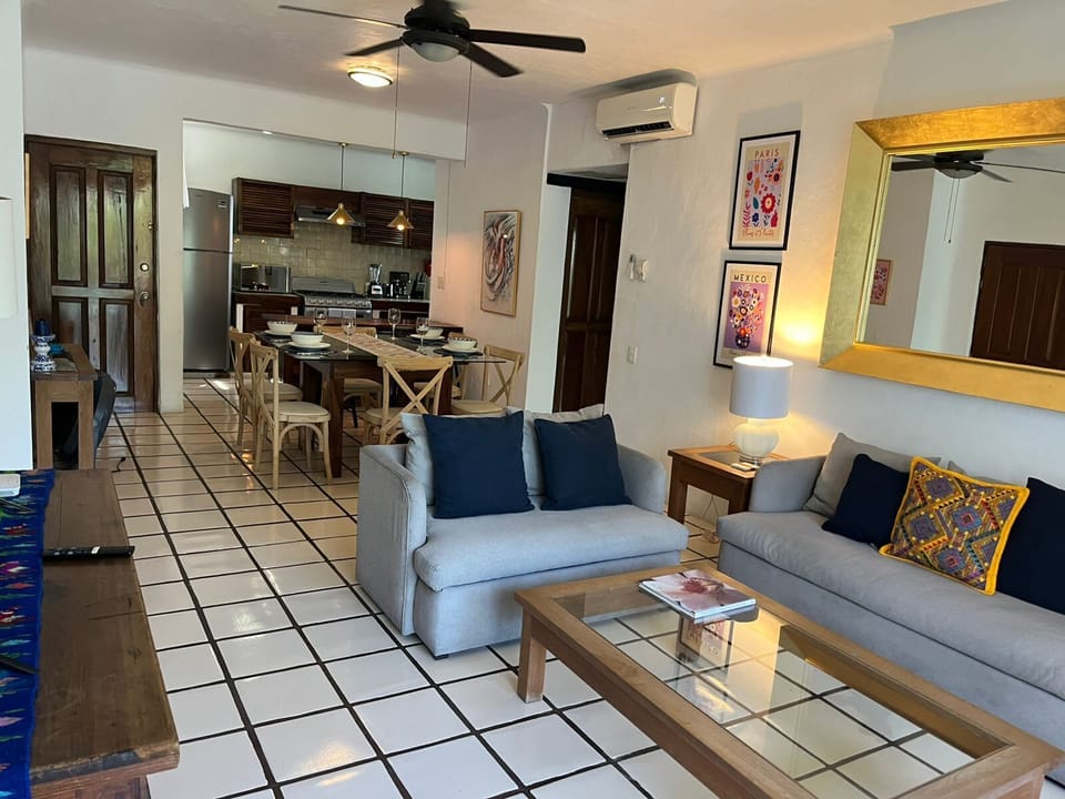 Cozy dining area for 6 with bright living room.