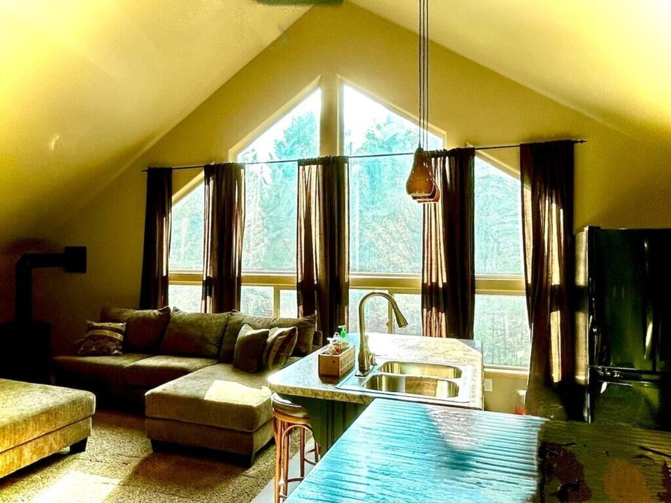 Relax in the open living room as sunshine wanders in with the large windows. 