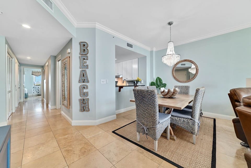 The condo boasts an open-concept design, elegant travertine tile.  