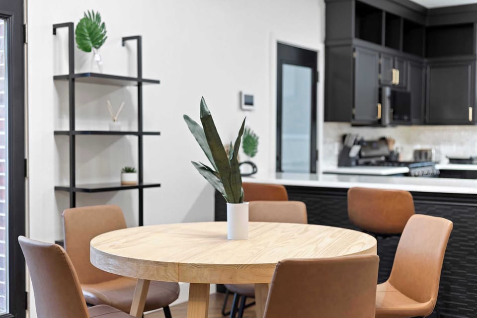 Enjoy the best of open-concept living in this bright, modern space, featuring a sleek chef’s kitchen and a light wood kitchen table perfect for morning coffee or casual meals.
