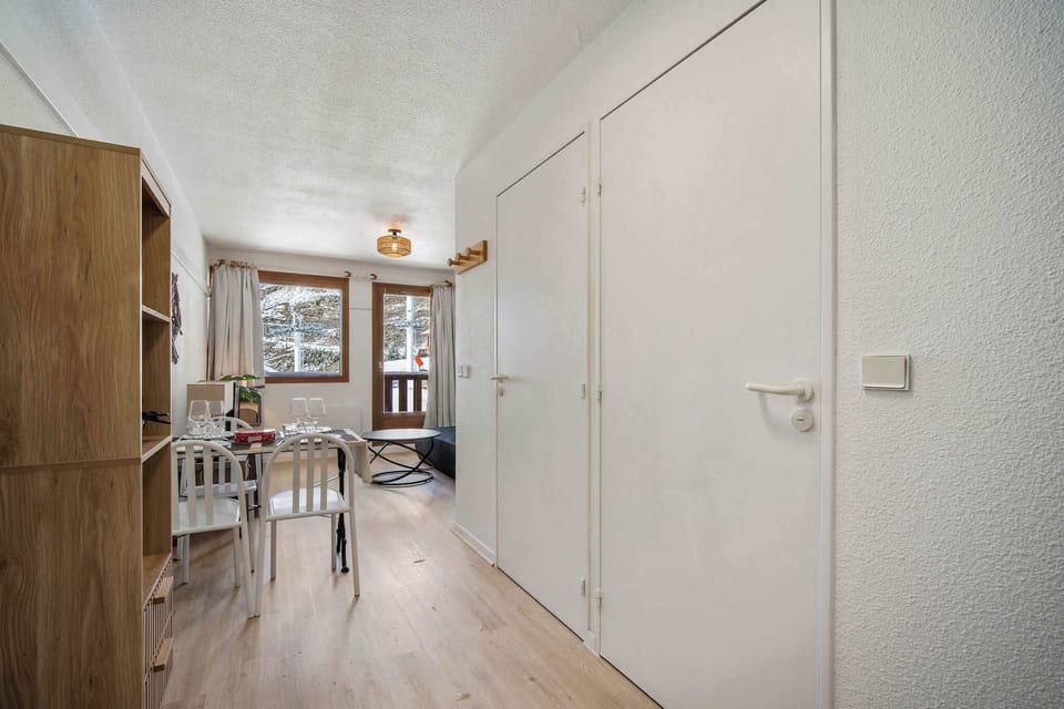 Neat and modern hallway leading to the living area — a welcoming space for your Val Thorens stay.