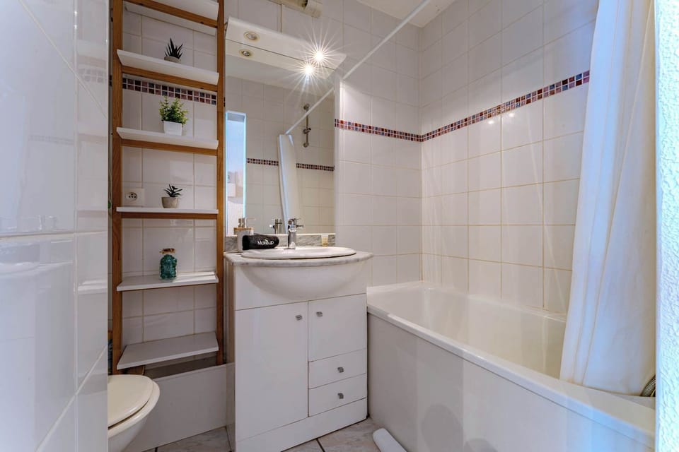 Elegant Bathroom with bathtub Freshen up in a modern bathroom featuring a sleek walk-in shower and premium amenities.