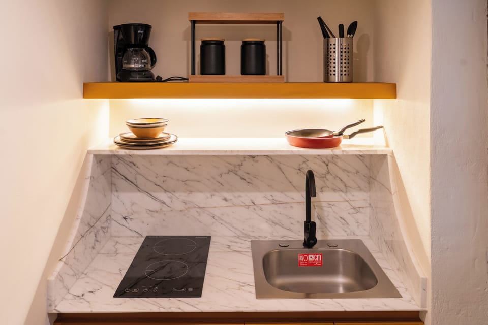 Mini-fridge, cleaning supplies, paper towels