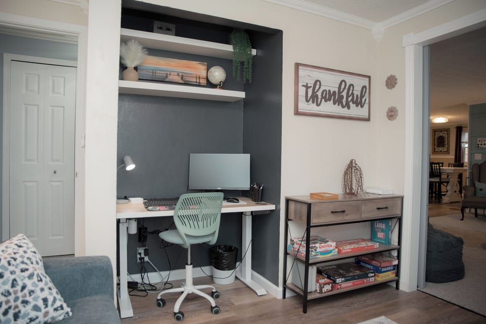 Workspace with desk nook, ergonomic chair, and plenty of light for remote work.