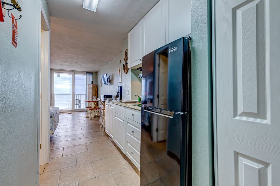 This bright coastal kitchen leads straight to stunning ocean views. Enjoy all the essentials for your beach stay, with natural light and seaside scenery enhancing every moment of your getaway.